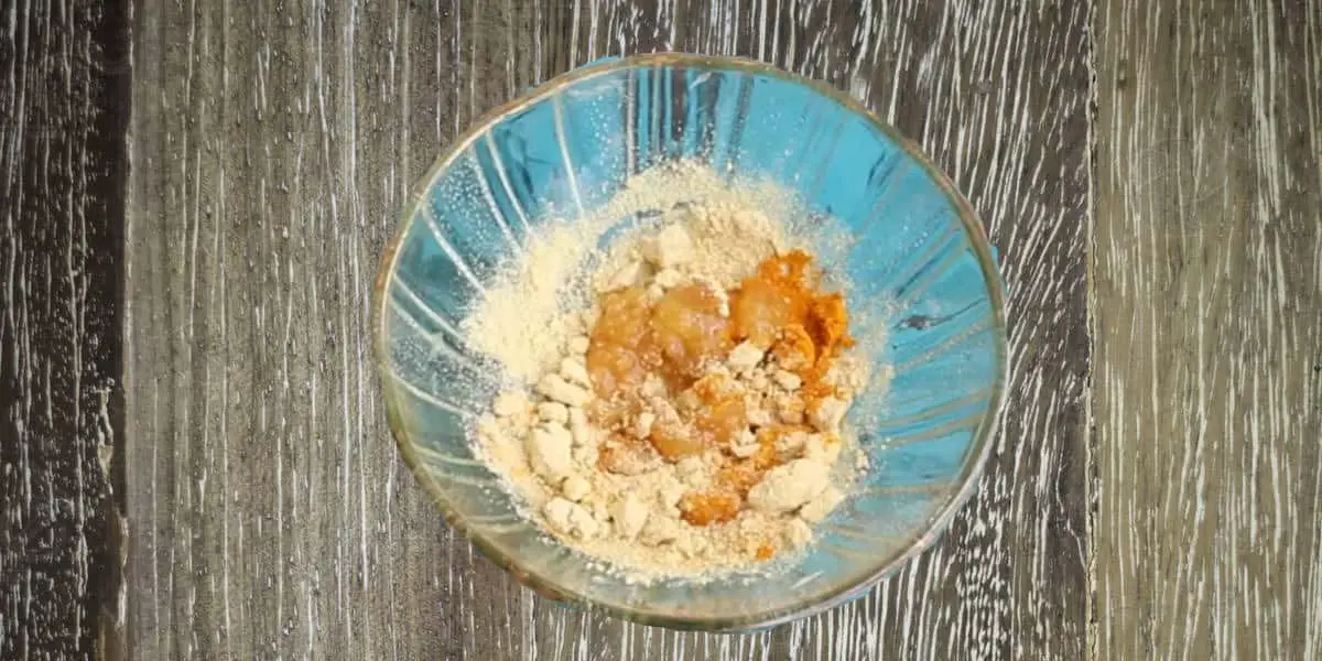 orange peel powder in a bowl mixed with turmeric and honey